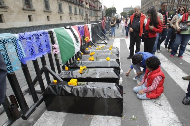Un grupo de personas instaló una ofrenda de día de muertos frente a la puerta principal de Palacio Nacional, dedicada a las seis personas que murieron en los hechos violentos del 26 y 27 de septiembre en Iguala. Foto: La Jornada