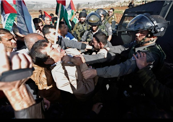 Un soldado israelí arremete contra el funcionario palestino Ziad Abu Ein (a la izquieda) durante una manifestación cerca de la ciudad cisjordana de Ramalá. Abu Ein murió poco después de ser golpeado. Foto Reuters