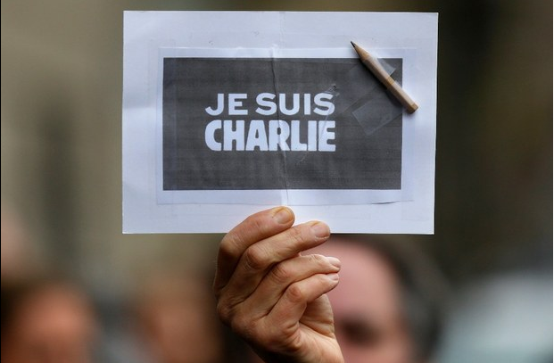 Una persona sostiene un papel con un lápiz donde se lee: Yo soy Charlie, durante un minuto de silencio en Estrasburgo en memoria de las víctimas del ataque al semanario francés. Foto Reuters